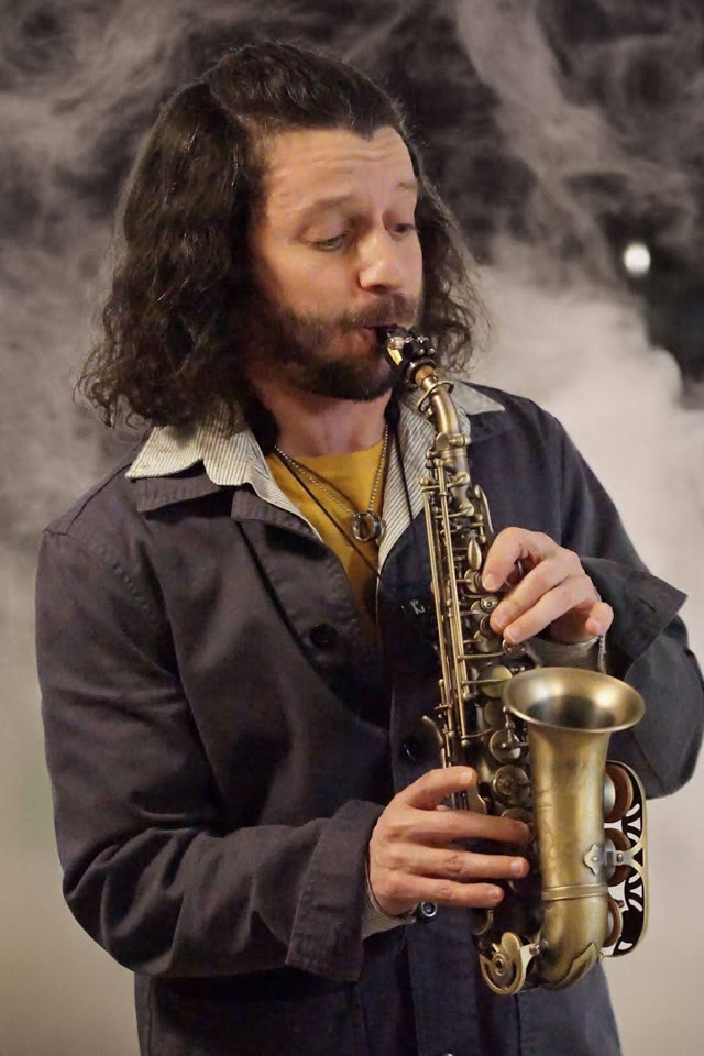 Sam playing a curved soprano saxophone